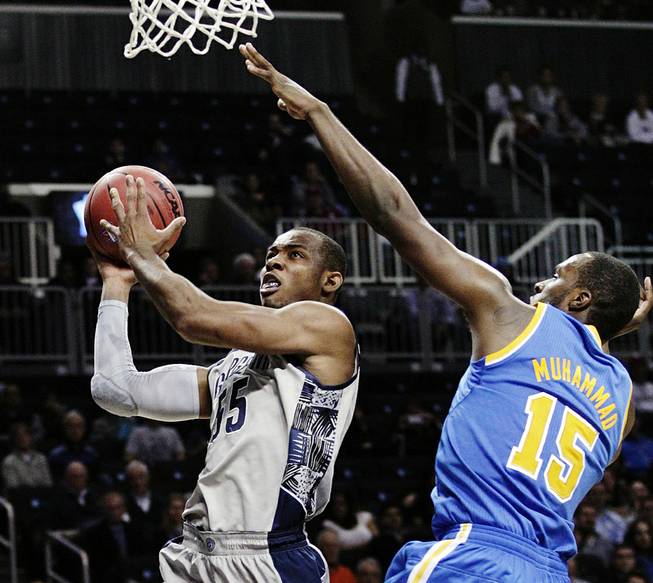 Georgetown's Jabril Trawick (55) drives past UCLA's Shabazz Muhammad (15) in the second half of their NCAA college basketball game in the Legends Classic, Monday, Nov. 19, 2012, in New York. Georgetown won 78-70.