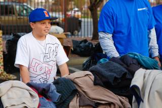 9 year-old Blaze Trumble hands out jackets to the homeless at the Las Vegas Rescue Mission the day before Thanksgiving, Wednesday, Nov. 21, 2012. Blaze started a blanket and jacket donation drive when he was 6 year-old and has continued the charitable tradition ever since.