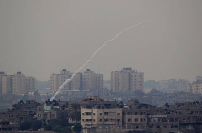A rocket fired by Palestinian militants from the Gaza Strip towards Israel is about to explode inside the Gaza Strip as seen from the border between Gaza strip and Southern Israel, Wednesday, Nov. 21, 2012, before a truce in the fighting was announced.