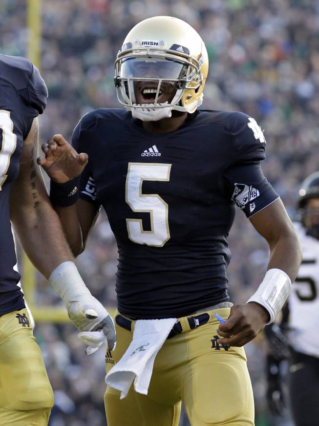 Notre Dame quarterback Everett Golson reacts after throwing for a touchdown against Wake Forest during the first half of an NCAA college football game in South Bend, Ind., Saturday, Nov. 17, 2012.