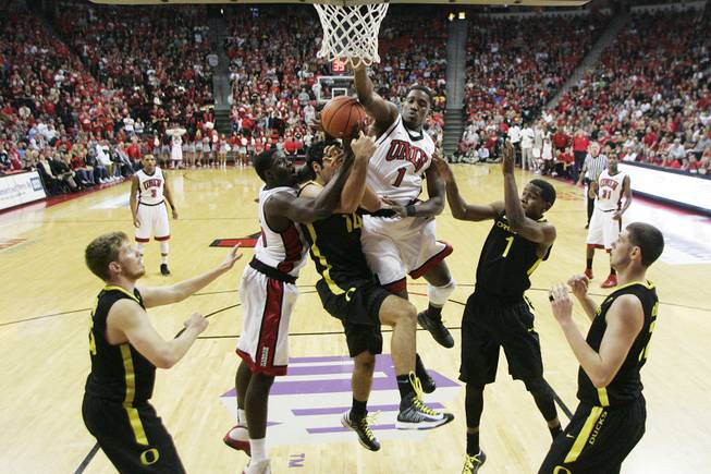 UNLV forward Anthony Bennett, left, and Quintrell Thomas defend Oregon forward Arsalan Kazemi during their game Friday, Nov. 23, 2012 in the Global Sports Classic. Oregon upset the 18th-ranked Rebels 83-79.