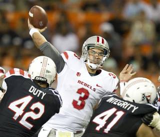 Hawaii defensive lineman Paipai Falemalu (42) and linebacker Art Laurel (41) put the pressure on UNLV quarterback Nick Sherry (3) as Sherry throws a pass in the third quarter of an NCAA college football game Saturday, Nov. 24, 2012, in Honolulu. (AP Photo/Eugene Tanner)