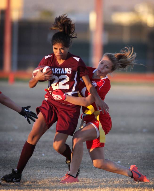 Francesca D'Arienzo of Arbor View goes for the flag of Briana Callejo of Cimarron-Memorial during their girls flag football game at Cimarron-Memorial High School on Monday, November 26, 2012.
