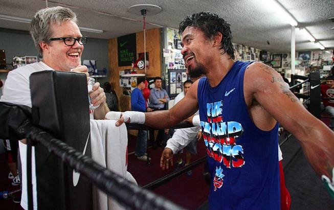 Nov. 27, 2012, Hollywood, Calif.  ---  Filipino boxer Manny Pacquiao talks with trainer Freddie Roach, left,  at the Wildcard Boxing Club as he prepares for the upcoming fourth fight of his rivalry against Mexican boxer Juan Manuel Marquez. The boxers will fight for the fourth time when they battle at the MGM Grand Garden Arena in Las Vegas on Saturday, Dec. 8, 2012.