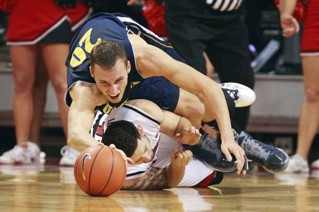 UC Irvine forward Adam Folker falls on top of UNLV forward Carlos Lopez-Sosa while chasing a ball during their game Wednesday, Nov. 28, 2012 at the Thomas & Mack.