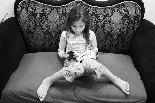 Zabraamalatzka Rosales-Gonzales, 8, reads at home in Las Vegas on Wednesday, November 28, 2012.