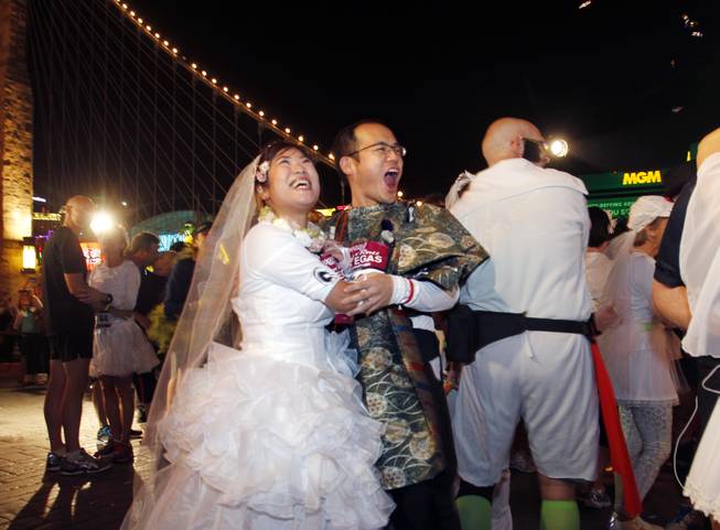 Akiko Hashimoto, left, and Toshihide Miyake celebrate after getting married ...