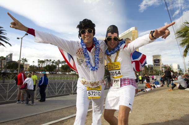 Runners David Gadd, left of Canada and Andy Miller of England strike a pose before the Zappos.com Rock 'n' Roll Las Vegas Marathon Sunday, Dec. 2, 2012.