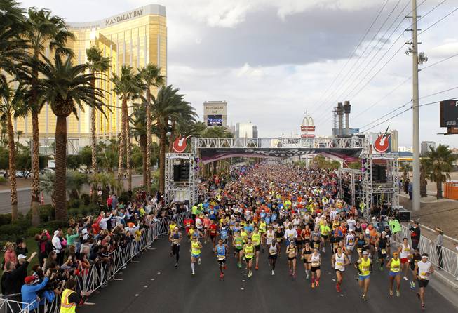 The first group of runners heads out during the Zappos.com Rock 'n' Roll Las Vegas Marathon Sunday, Dec. 2, 2012.