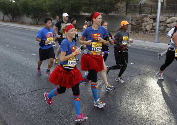 A pair of women with Superman T-shirts run during the Zappos.com Rock 'n' Roll Las Vegas Marathon Sunday, Dec. 2, 2012.