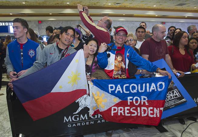 Fans of Filipino boxer Manny Pacquiao wait for Pacquiao to arrive at the MGM Grand Tuesday, December 4, 2012. Pacquiao will take on Juan Manuel Marquez of Mexico in a welterweight bout at the MGM Grand Garden Arena on Saturday. It will be the fourth time for the boxers to fight each other.