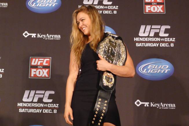 Ronda Rousey shows off her UFC bantamweight championship belt, on Thursday Dec. 6, 2012. UFC president Dana White handed out the belt, saying the former Strikeforce title-holder will make her UFC debut on Feb., 23 against Liz Carmouche.