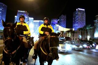 Officers Cody Bunn, left, and Tim Ruiz of the Metro Police Mounted Unit patrol the Las Vegas Strip on Friday, Dec. 7, 2012.