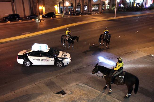 The Las Vegas Metropolitan Police Mounted Unit pulls over a taxi on Harmon Avenue just east of the Las Vegas Strip on Friday, December 7, 2012.