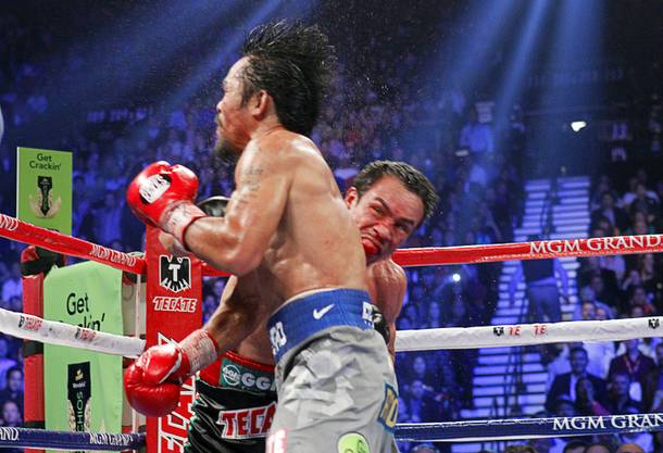 Manny Pacquiao of the Philippines is knocked out by a punch from Juan Manuel Marquez of Mexico during the sixth round of their welterweight fight at the MGM Grand Garden Arena in Las Vegas, Nevada December 8, 2012.