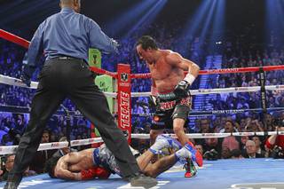 Juan Manuel Marquez (R) of Mexico steps away after knocking out Manny Pacquiao of the Philippines in the 6th round during their welterweight fight at the MGM Grand Garden Arena in Las Vegas, Nevada December 8, 2012.