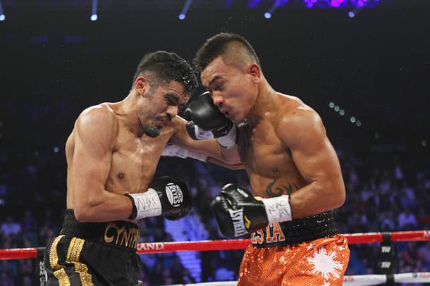 IBF lightweight champion Miguel Angel Vazquez (L) of Mexico exchanges blows against Mercito Gesta of the Philippines during their title bout at the MGM Grand Garden Arena in Las Vegas, Nevada December 8, 2012.