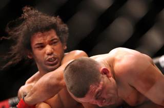 UFC lightweight champion Benson Henderson, left, in action against Nate Diaz during their mixed martial arts bout at a UFC on FOX 5 event in Seattle on Saturday, Dec. 8, 2012. Henderson retained his title via a unanimous five-round decision. 