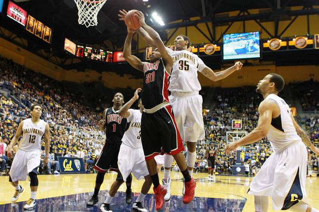 UNLV guard Justin Hawkins drives to the basket while being defended by Cal forward Richard Solomon during the first half of their game Sunday, Dec. 9, 2012 at Haas Pavilion in Berkeley, Calif.