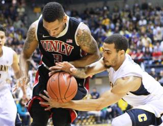 Cal guard Justin Cobbs tries to grab a loose ball from UNLV guard Anthony Marshall during the first half of their game Sunday, Dec. 9, 2012 at Haas Pavilion in Berkeley, Calif. UNLV won 76-75.