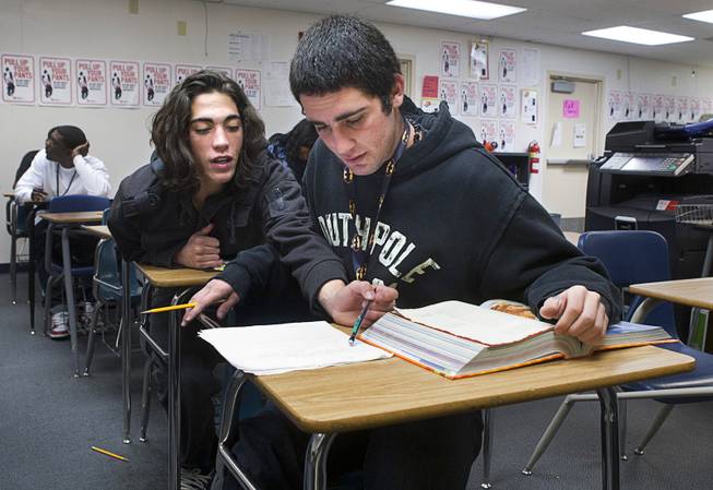 Aalik Poeling, left, comments on his brother's essay during an English class at Desert Rose Adult High School in North Las Vegas on Monday, Dec. 11, 2012. Aarik Poeling was kicked out of four Clark County School District schools for fighting, while Aalik dropped out his freshman year and began selling drugs. The twin brothers, now 18 years old, are trying to get their lives in order and graduate high school.