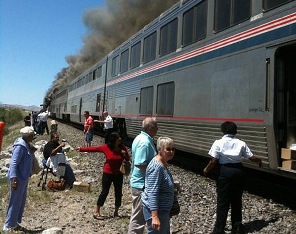 In this photo provided by Ron Almgren, passengers and Amtrak train staff are seen at the site of a collision between an Amtrak westbound train and a truck on  U.S. 95 about four miles south of Interstate 80 on Friday, June 24, 2011, about 70 miles east of Reno, Nev.