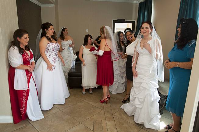 Brides wait in the lobby before a group wedding at the Chapel of the Flowers on Las Vegas Boulevard South Wednesday, Dec. 12, 2012. Twelve couples got married at 12:12 pm at the chapel as part of a KOMP 92.3 radio station promotion. Las Vegas wedding chapels were busy all day as many couples wanted to get married on the date of 12-12-12.