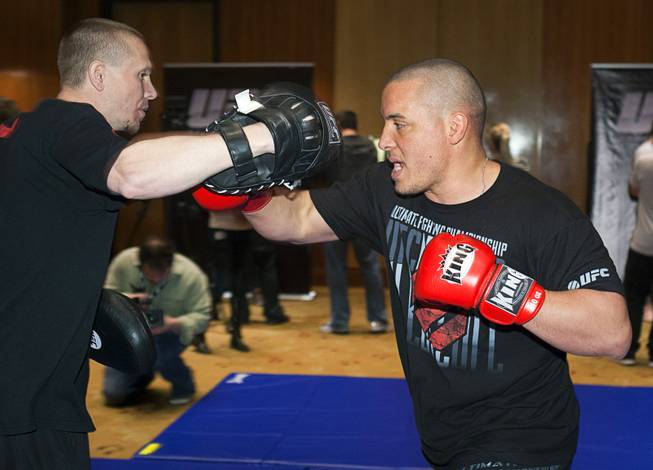 Heavyweight fighter Pat Barry, right, works on his timing with Trevor Wittman during UFC Ultimate Fighter Finale workouts at the Hard Rock Thursday, Dec. 13, 2012.