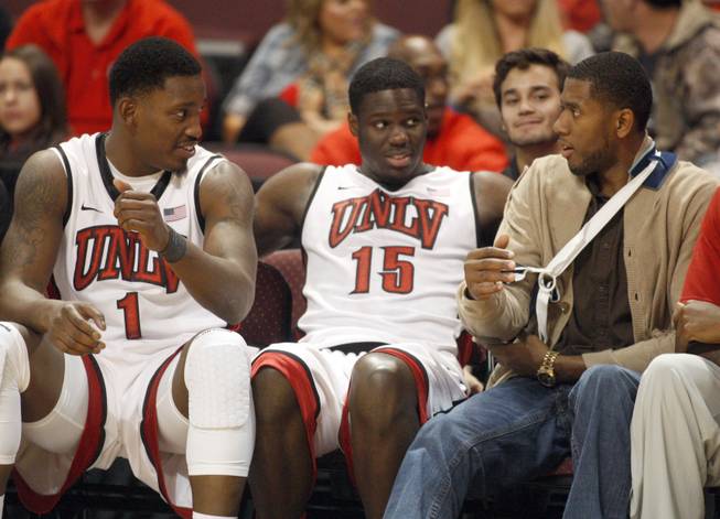 Mike Moser, right, talks with Quintrell Thomas, left, and Anthony Bennett during UNLV's game against the La Verne Leopards at the Orleans Arena Thursday, Dec. 13, 2012.