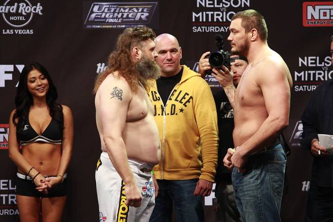 Roy Nelson, left, and Matt Mitrione face off during weigh-ins for the Season 16 finale of "The Ultimate Fighter" Friday, Dec. 14, 2012, at the Joint in the Hard Rock Hotel.