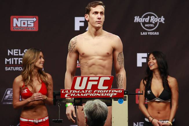 Mike Ricci stands on a scale during weigh-ins for the Season 16 finale of "The Ultimate Fighter" Friday, Dec. 14, 2012, at the Joint in the Hard Rock Hotel.