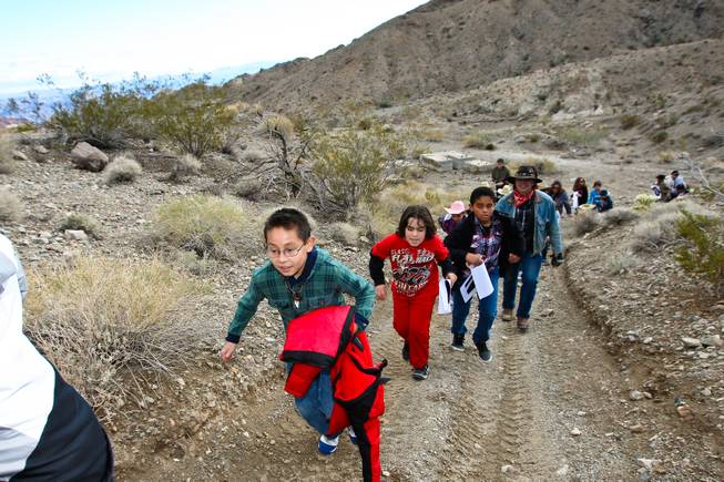 Scholarship recipient Daniel Reyes races his classmates up the trails in search of gold at the Eldorado Canyon Mine as part of the In12Days 'Ten Lords A-Leaping' celebration Saturday, December 15, 2012.