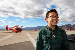 Scholarship recipient Daniel Reyes grins ear to ear after learning he gets to fly on a Papillon helicopter to greet his classmates from Mountain View Christian School at Eldorado Canyon Mine as part of the In12Days 'Ten Lords A-Leaping' celebration at the Boulder City Municipal Airport Saturday, December 15, 2012.