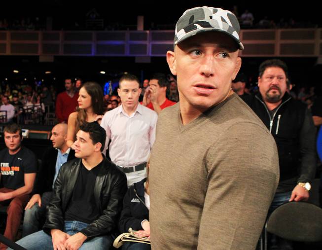 Georges St. Pierre heads to his seat at "The Ultimate Fighter 16" Saturday, Dec. 15, 2012, at the Joint in the Hard Rock Hotel. It was announced that St. Pierre's next fight would be against Nick Diaz.