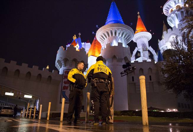Metro Police officers stand watch outside the entrance to the Excalibur hotel-casino after a shooting near the registration desk left two dead, Friday, Dec. 14, 2012, in Las Vegas.