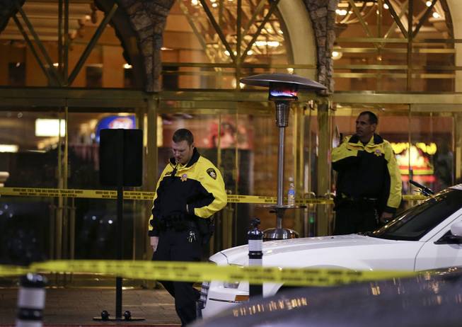 In a Dec. 14, 2012, file photo, Metro Police officers stand watch outside the entrance to the Excalibur after a shooting near the registration desk left two dead. 