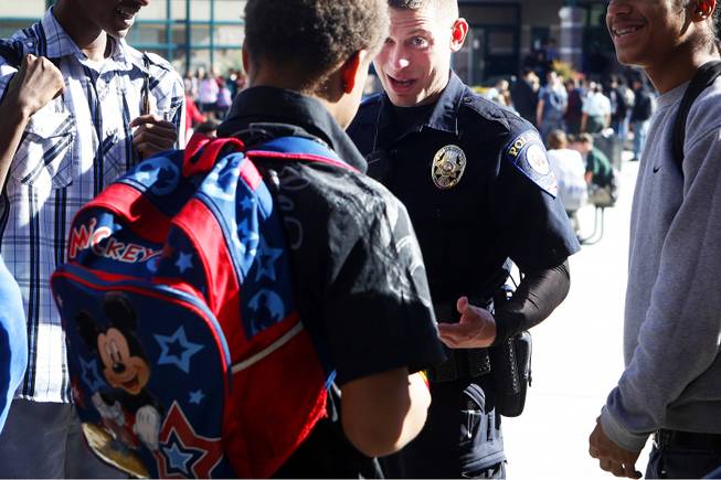 In this November 2011 file photo, Clark County School District Police officer John Maier talks with students during lunch at Mojave High School in North Las Vegas. CCSD and Metro Police say they'll continue an increased police presence in and around Clark County schools in the wake of last week's shootings at Sandy Hook Elementary School in Newtown, Conn.