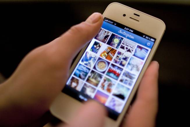 In this Monday, April 9, 2012, file photo, Instagram is demonstrated on an iPhone, in New York.