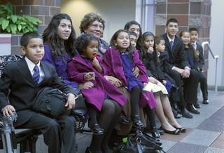 Maciel children sit with their grandmother Daisy at family court Thursday, Dec. 20, 2012. The family officially adopted four more children for a total of eleven children.