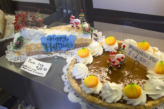 A Yule log and a pumpkin pie are displayed at Chef Flemmings Bake Shop, a European-style bakery, on Water Street in downtown Henderson Thursday, Dec. 20, 2012.
