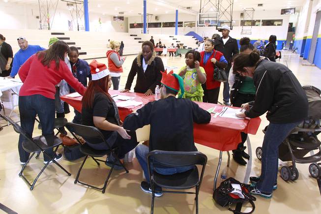 People line up to receive a gift card worth $500, thanks to the largess of an anonymous "Secret Santa" who donated $1 million for families in southern Nevada Thursday, Dec. 20, 2012.