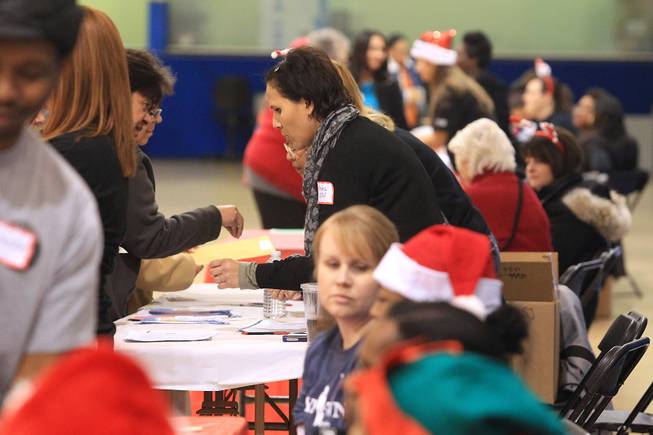 People line up to receive a gift card worth $500, thanks to the largess of an anonymous "Secret Santa" who donated $1 million for families in southern Nevada Thursday, Dec. 20, 2012.