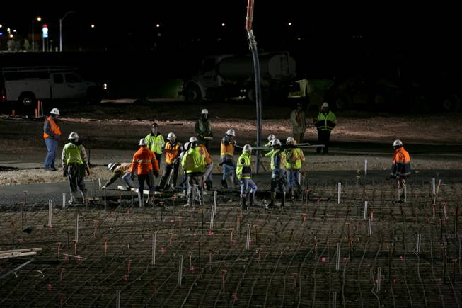 Construction workers manage the concrete pour as it's laid onto the site of the 17,000-square-foot wave pool at Las Vegas' newest attraction Wet 'n' Wild, a 41-acre water park expected to open in Spring of 2013, Thursday, Dec. 20, 2012.