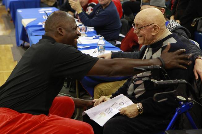 Former NBA player Michael Cage talks with Jerry Tarkanian between games in the inaugural Jerry Tarkanian Classic Thursday, Dec. 20, 2012.