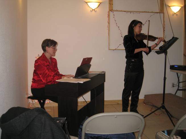 Pocatello music instructor and pianist Laura Larson and violinist Keum Hwa Cha of the Idaho State Civic Symphony in Pocatello, Idaho perform "Silent Night" during the holiday party at Lava Hot Springs Inn on December 20, 2012.