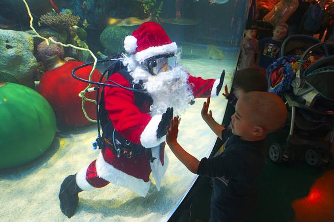 Children visit with an underwater Santa at the Silverton's  117,000-gallon aquarium Sunday, Dec. 23, 2012. Santa took Christmas present requests from children using an underwater microphone.
