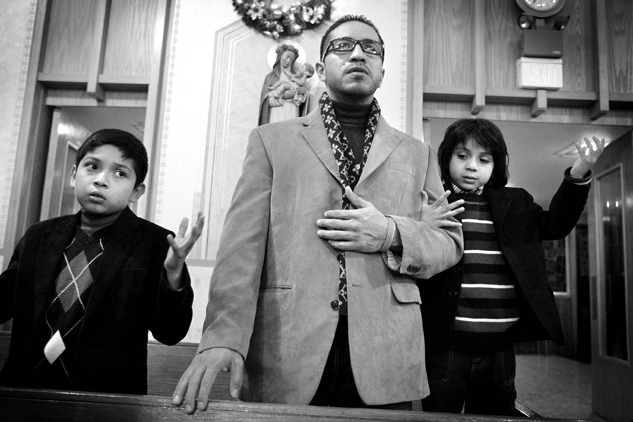 Arturo Martinez-Sanchez, center, attends Christmas Eve Mass with his sons, Cristopher, 10, left, and Alejandro, 5, at St. Christopher Catholic Church in North Las Vegas on Dec. 24, 2012.