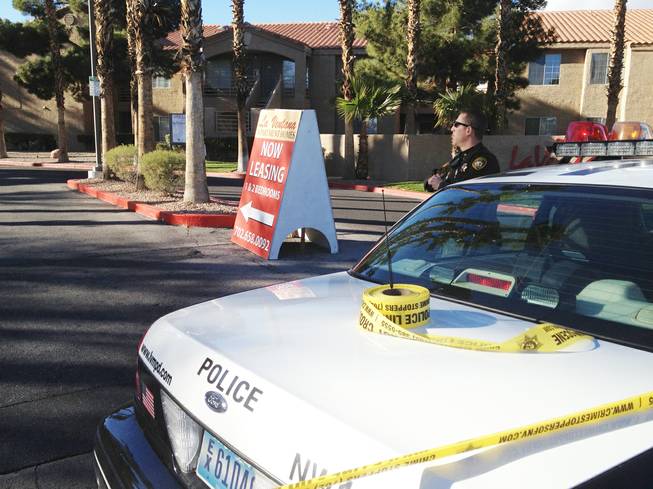 Police block off entry into La Ventana Apartment Homes, 2901 N. Rainbow Blvd., after a home invasion Monday morning, Dec. 24, 2012, left one suspect dead and three others on the run.