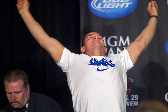 UFC heavyweight champions Junior Dos Santos of Brazil stretches during a news conference at the MGM Grand Thursday, Dec. 27, 2012. Dos Santos will defend the title against Cain Velasquez of San Jose, Calif. during UFC155 at the MGM Grand Garden Arena Saturday .