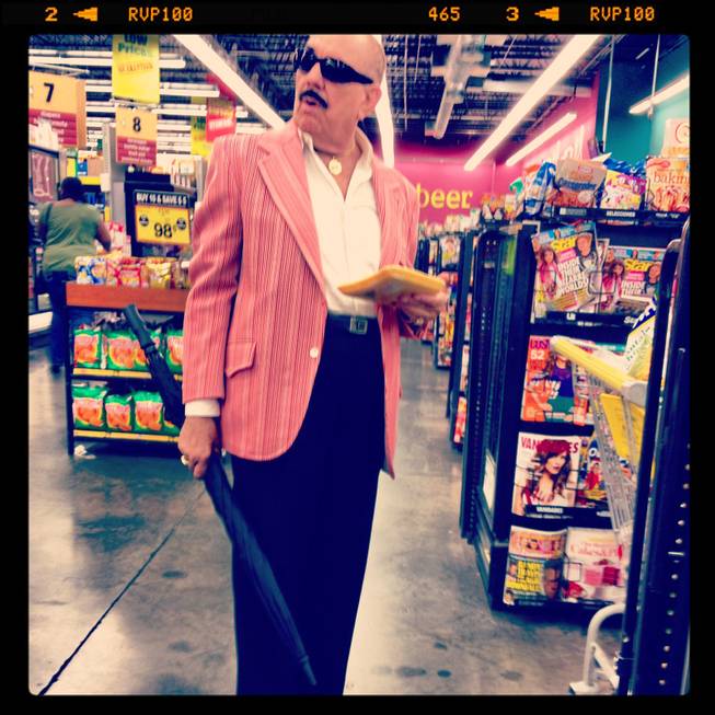 In this Instagram, a sharp dressed man waits in the checkout at a Las Vegas grocery store.